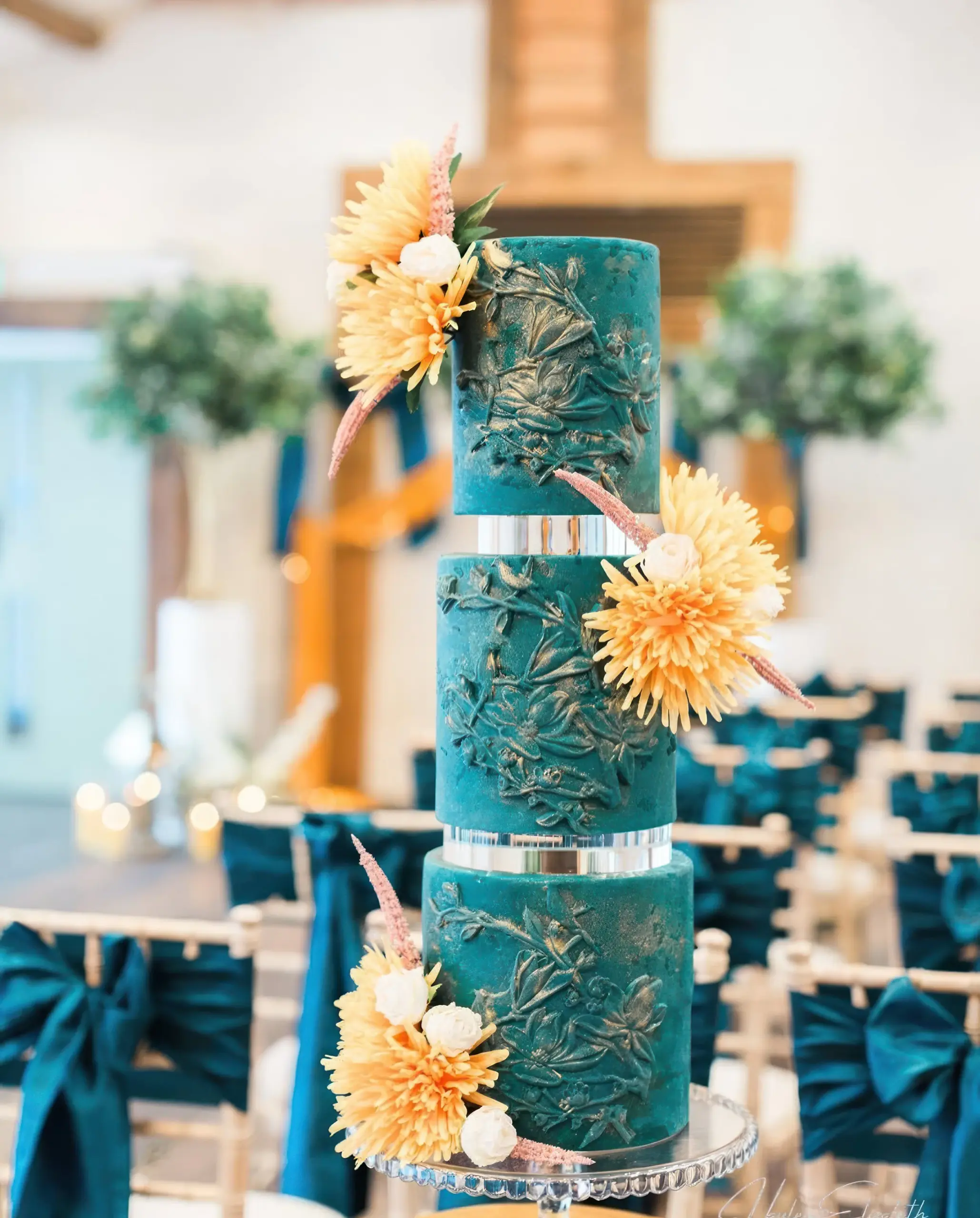 Teal and gold wedding cake on display at a Bennetts Willow Barn wedding