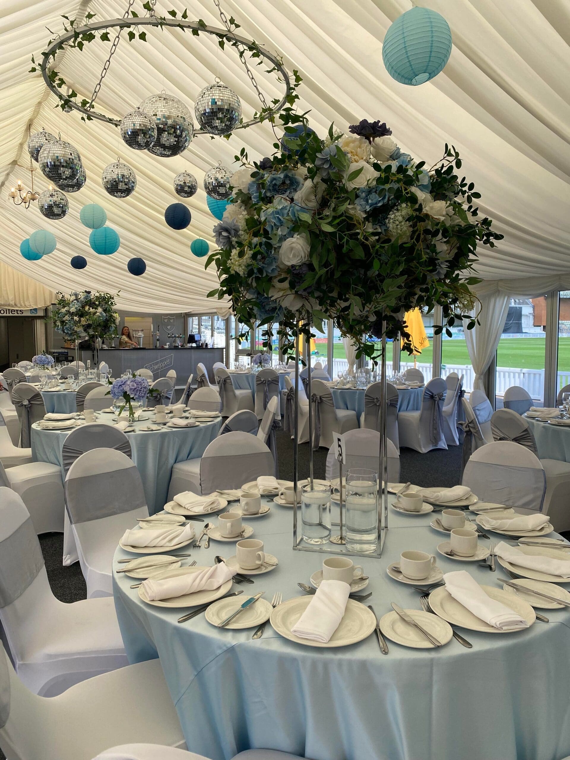 Wedding table with teal balloons and a floral centrepiece at a Worcester venue