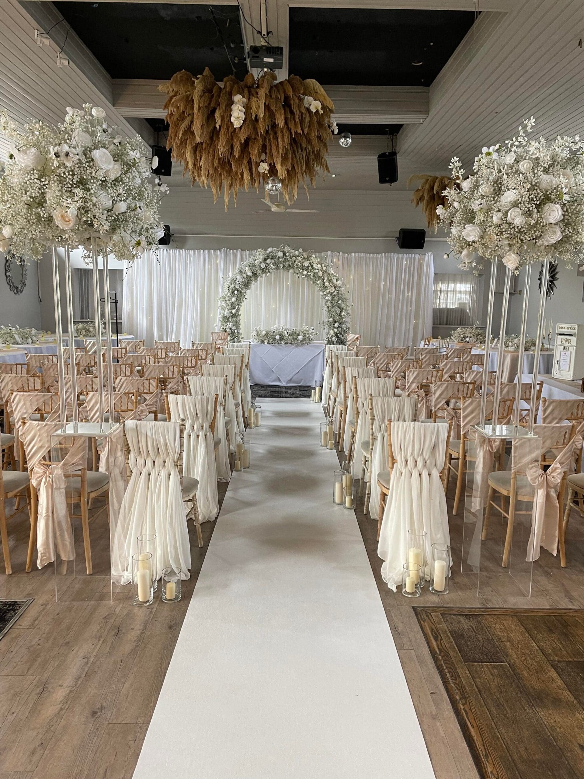 White ceremony aisle with a floral moon gate at The Fox Inn Stourton