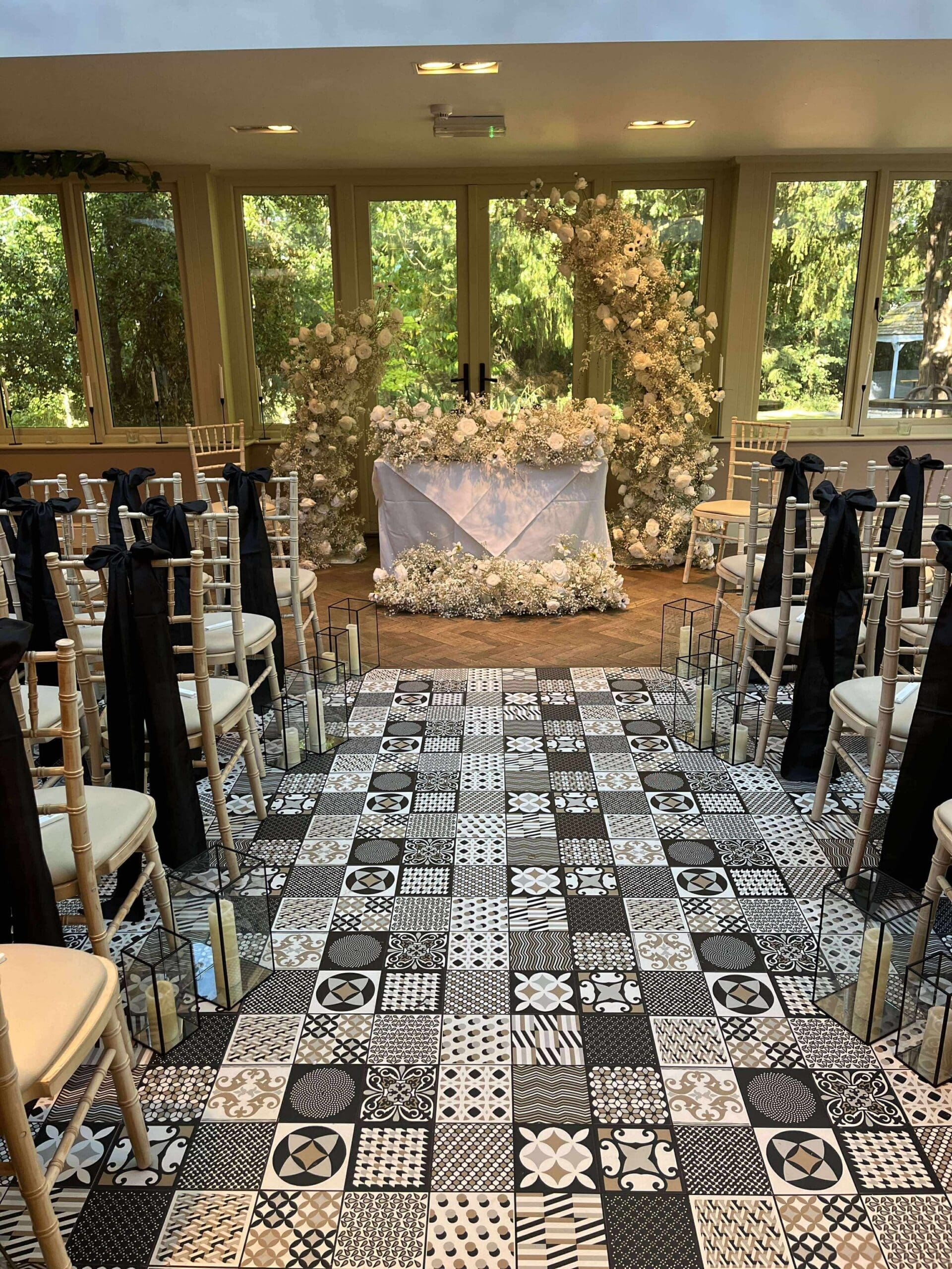 Monochrome tiled ceremony aisle with black drapes at Old Rectory House