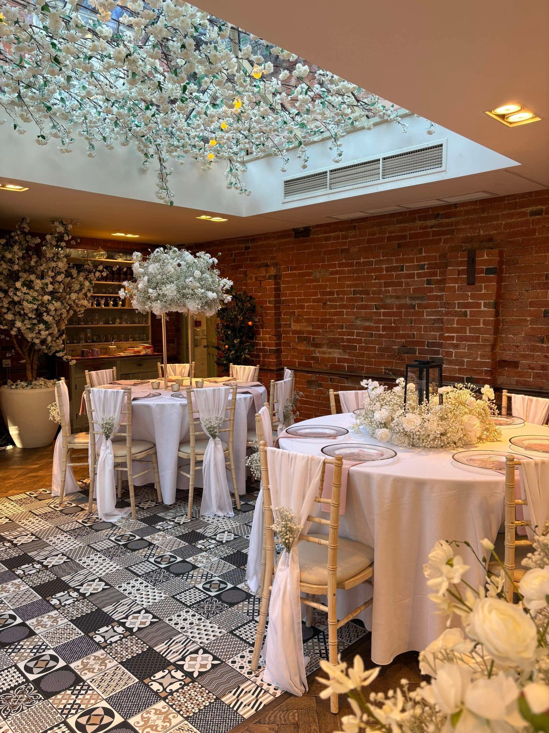 White blossom canopy above wedding tables at Old Rectory House