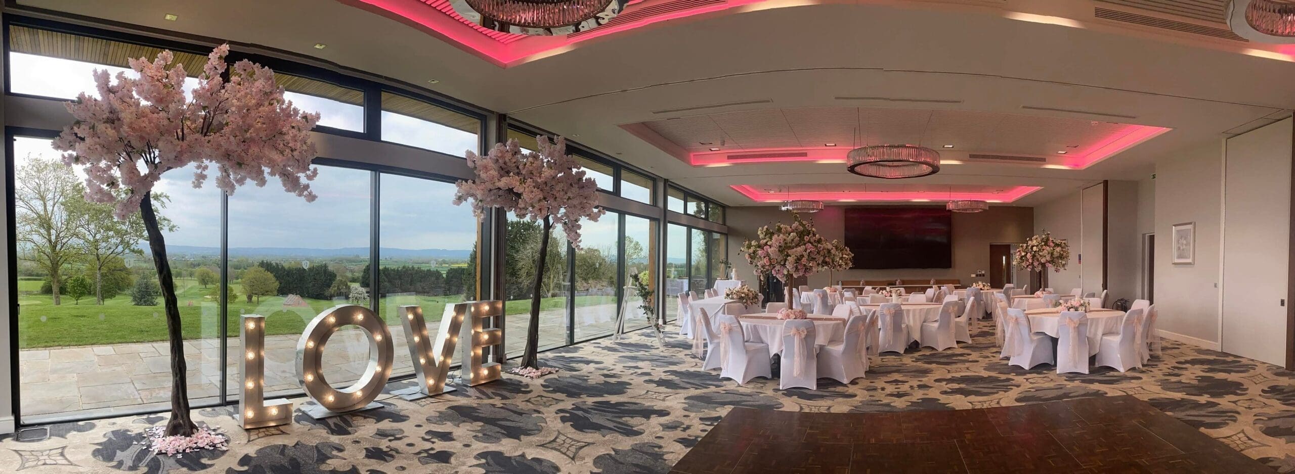 Panoramic wedding reception room with LOVE letters at Tewkesbury Park