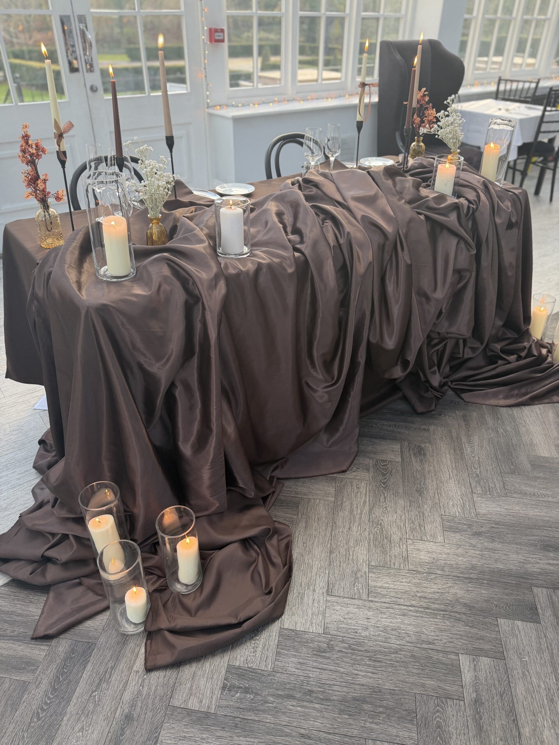 Bolts of draping fabric laid out before a wedding installation