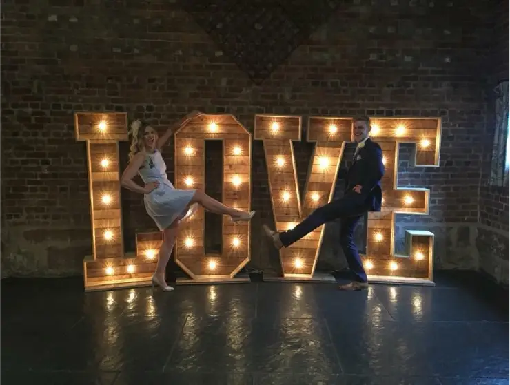Light-up LOVE letters with a couple silhouetted in front