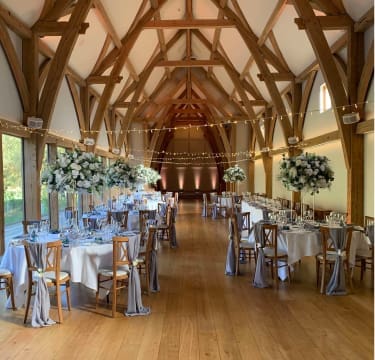 Elegant wedding ceremony styling with floral arch and aisle decor by The Wedding House in Worcestershire