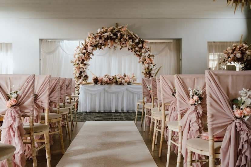 Styled wedding ceremony setup with elegant floral décor and coordinated venue styling by The Wedding House